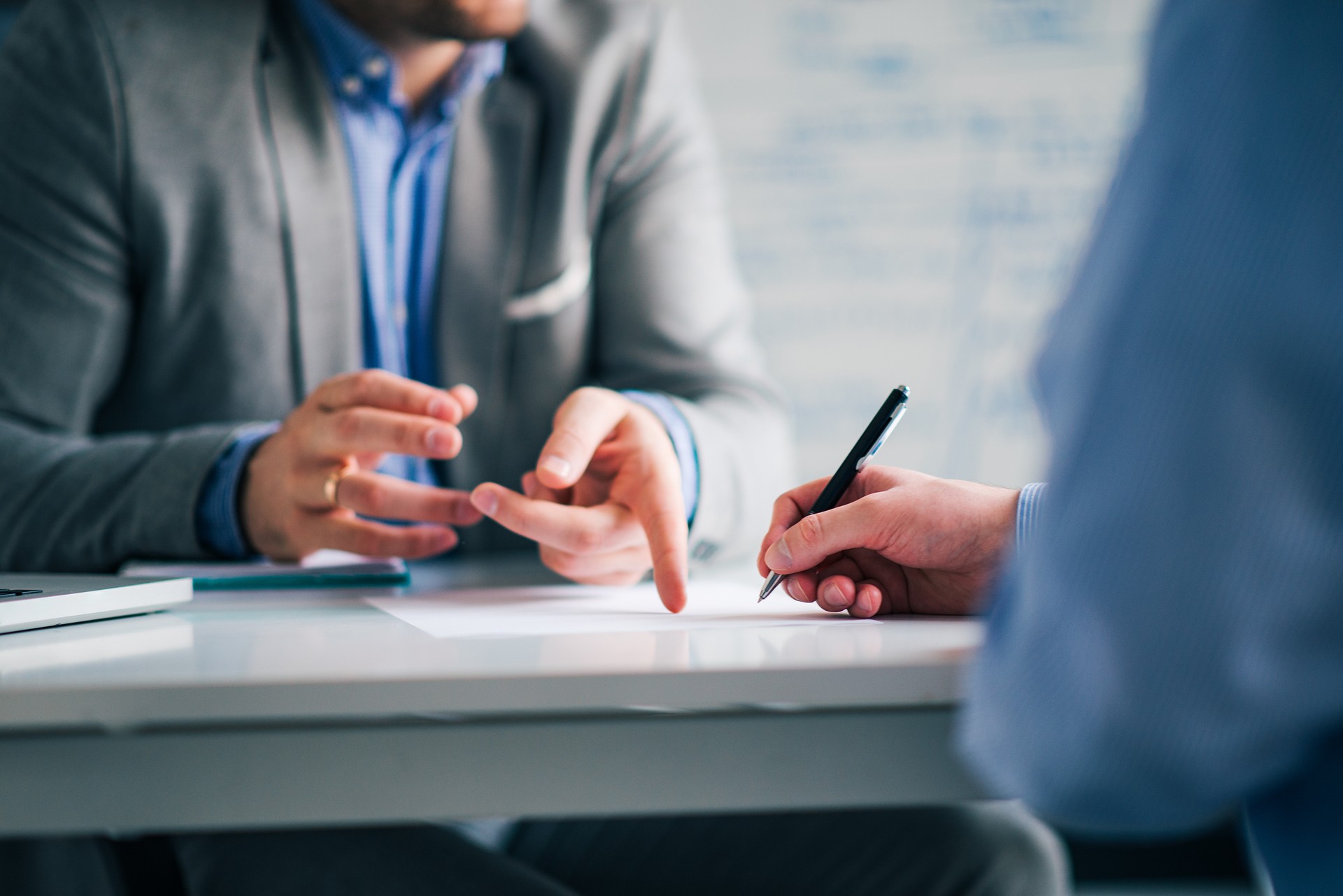 Business consultant and customer on a meeting in the office, signing contract.